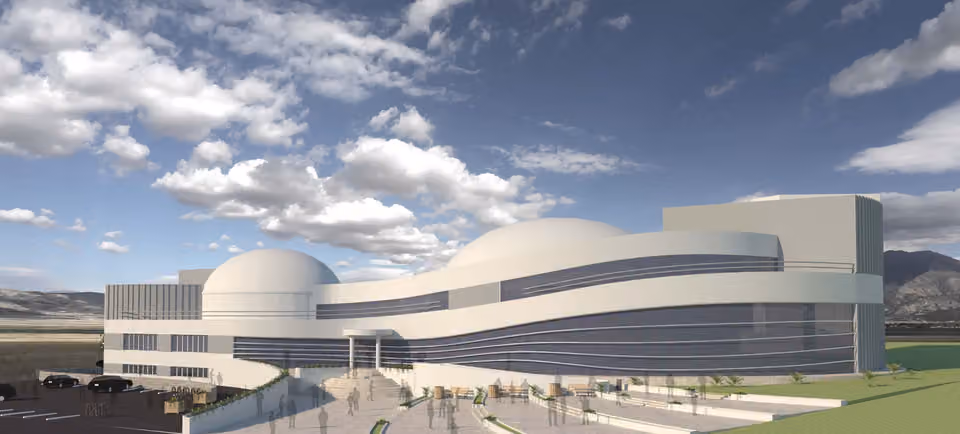 Render of a curving white building with two domes on a sloping site, with a stepped plaza in front.
